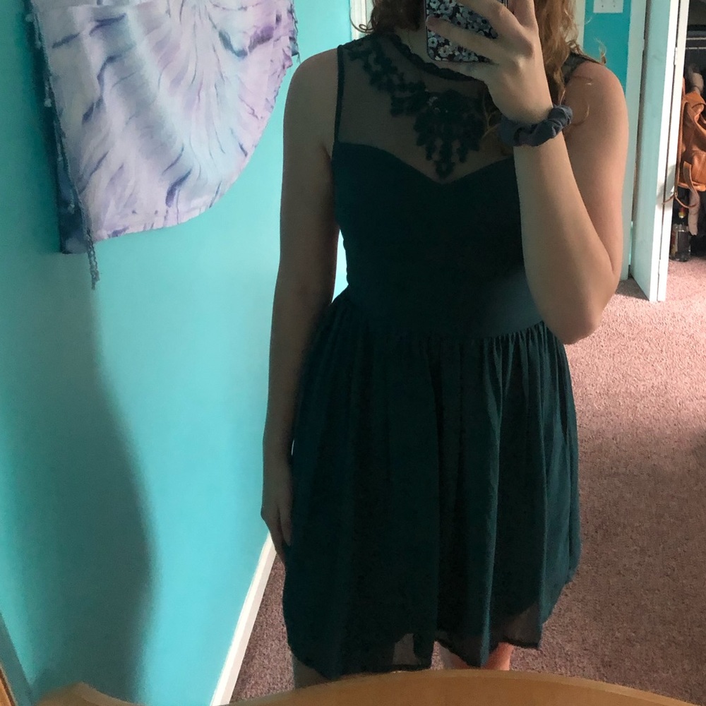 A dark green dress with a beaded top